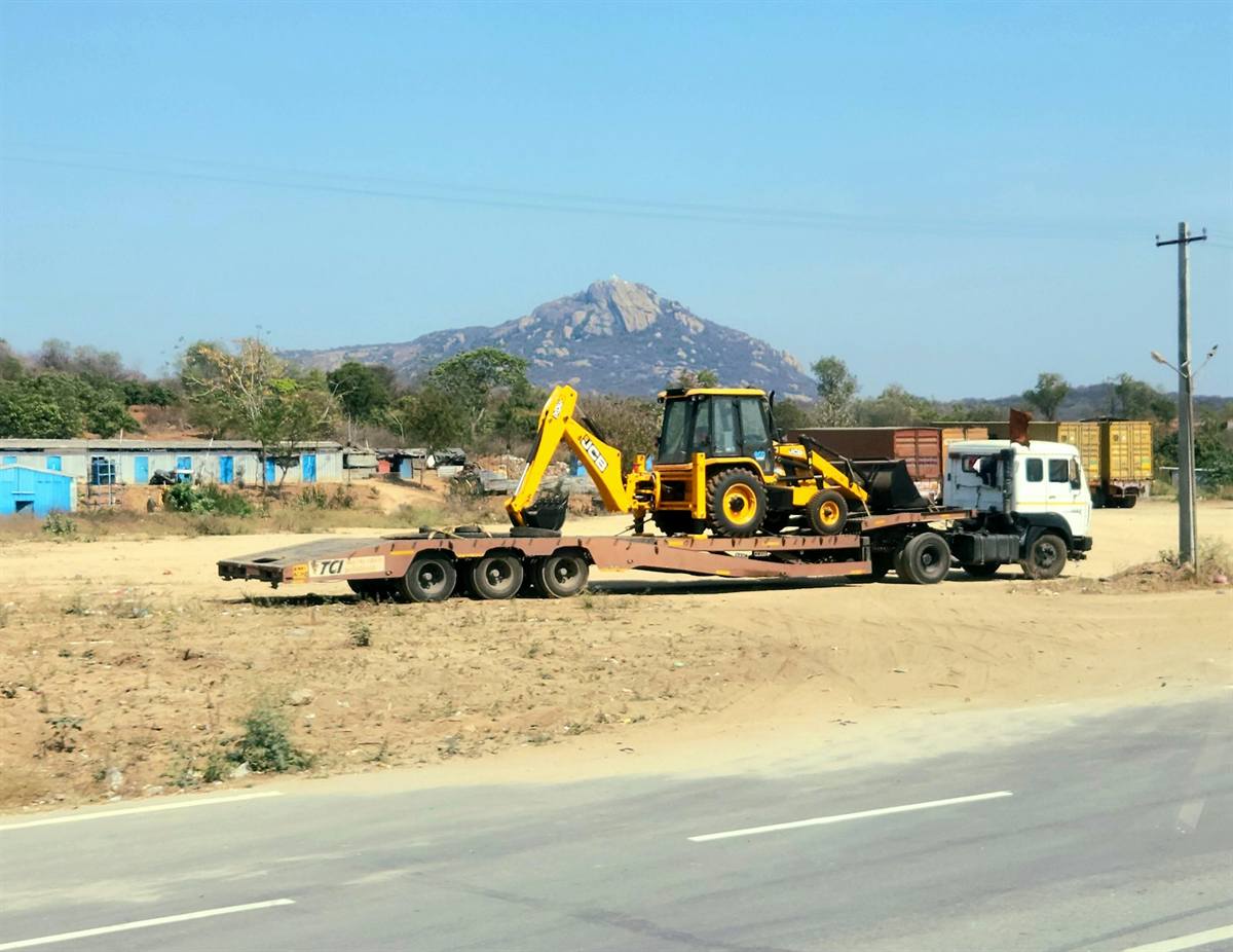 Heavy construction machinery hauled on a low-loader trailer